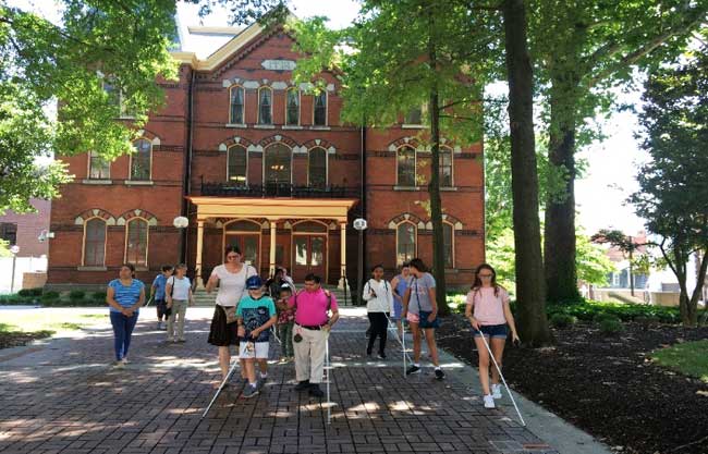 shows students leaving Salisbury City Hall building using their white canes.